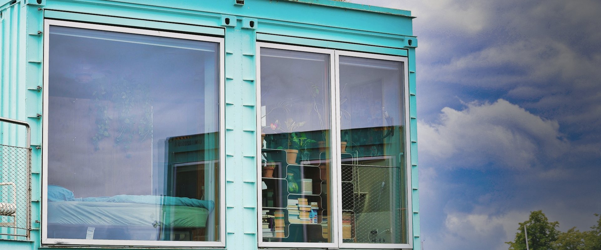 Converted shipping container building with large windows