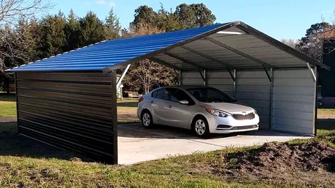 Steel carport with a blue roof and one enclosed side, a silver car parked inside.
